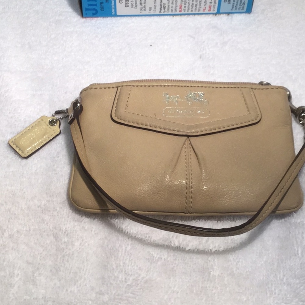 Tan leather Coach wristlet with hangtag